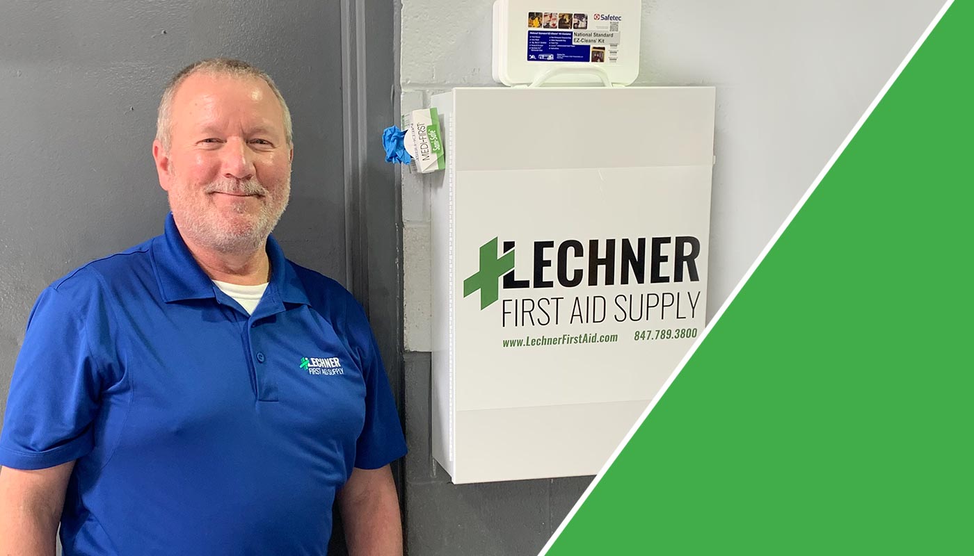 Lechner First Aid Sales Representative standing by a Lechner First Aid kit/First Aid Cabinet. 