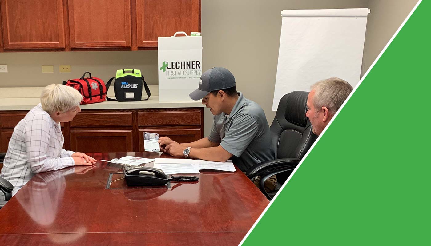 Lechner First Aid Sales Representatives discussing the benefits of a Lechner First Aid Program/ First Aid Service with a business owner. 