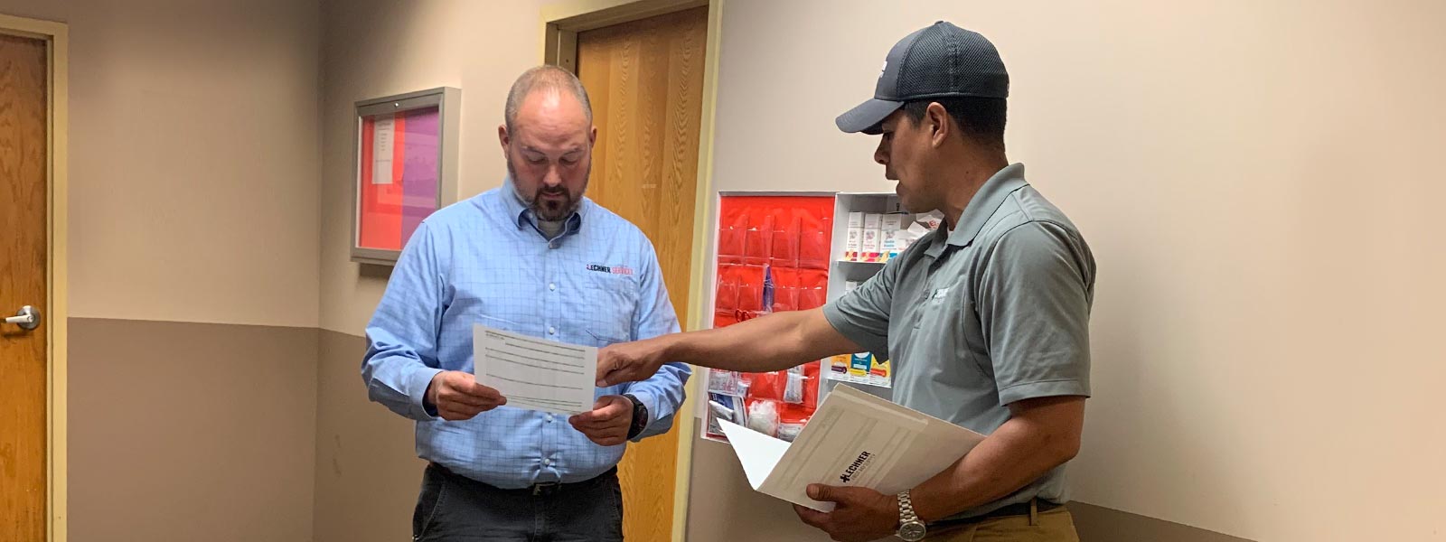 Lechner First Aid Sales Representatives discussing the benefits of a Lechner First Aid Program/ First Aid Service with a safety manager.